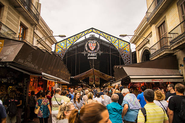 Barcelona, Spain - September 14, 2015: A big amount of people gather at the entrance of Mercado de la Boquería, Barcelona's most famous market