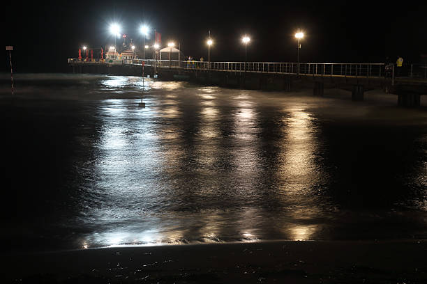 istock Bridge in the sea at night 488763936