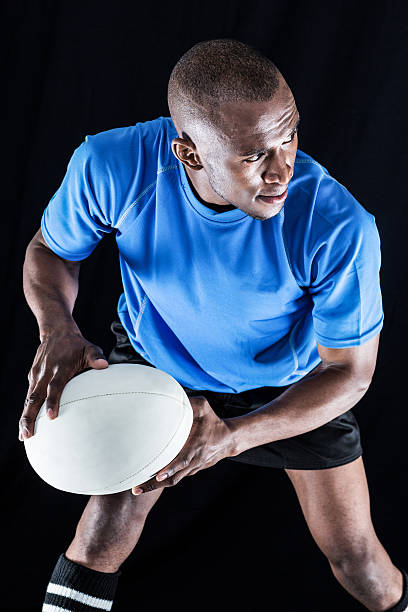 istock Confident sportsman looking away while playing rugby 488765578