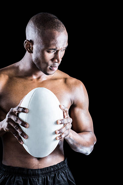 istock Concentrated shirtless athlete with rugby ball 488766118