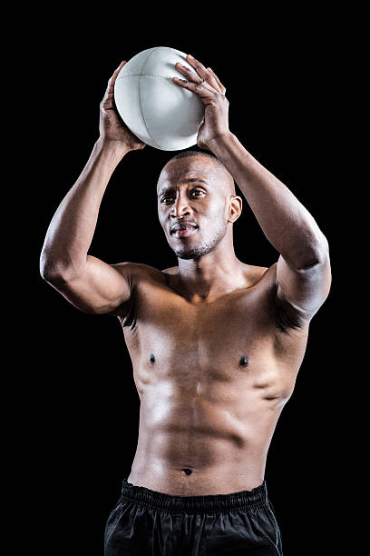 istock Shirtless athlete throwing rugby ball 488766208