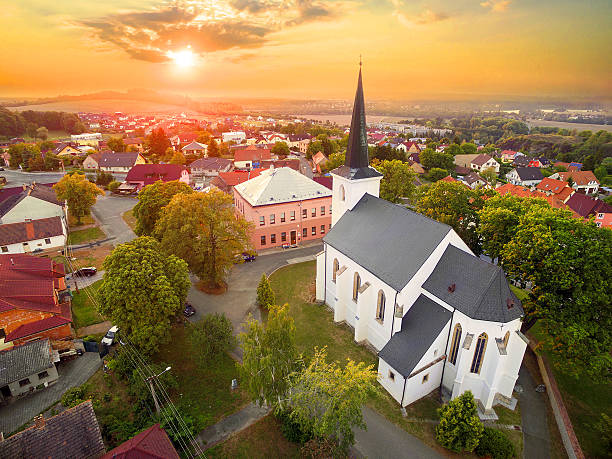 Aerial view to romantic citiscape. Beautiful sunset over gothic church St. Peter and Paul in The Litice suburb of Pilsen. Aerial view to romantic citiscape in Czech Republic, Central Europe. HDR (warm filtered) photography. pilsen stock pictures, royalty-free photos & images