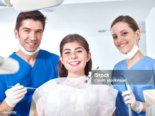 Dentist Assistant And Young Woman Similing For The Camera Stock Photo - Download Image Now