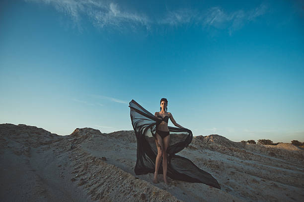 istock The girl in underwear among sand 488768162