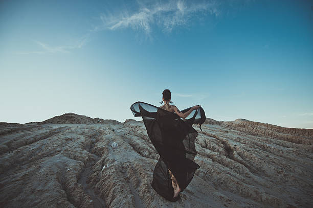 istock The girl with a developing fabric at sunset 488768592