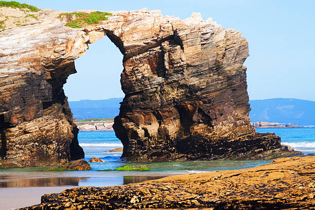 istock Natural arch at As Catedrais beach 488769044