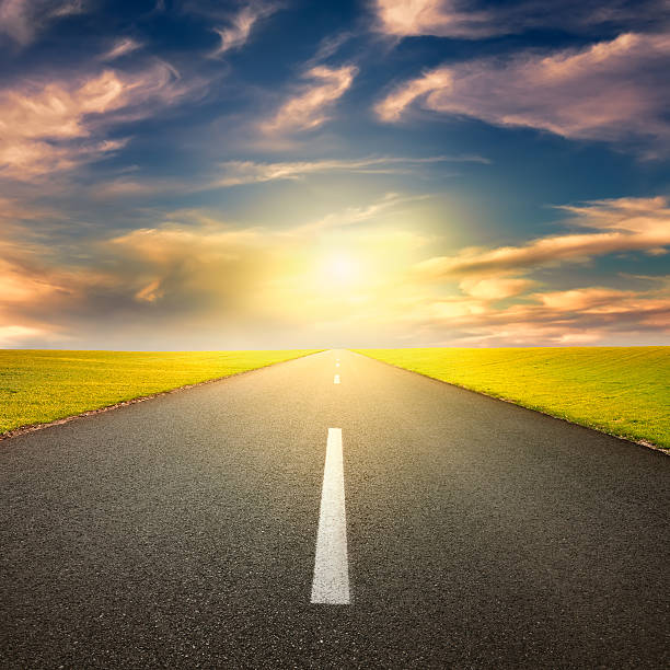 istock Driving on asphalt road towards the setting sun 488784033