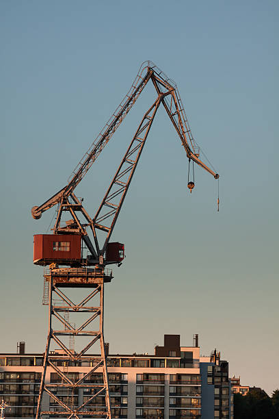 istock sea port cranes with blue cloudy sky in background 488784091