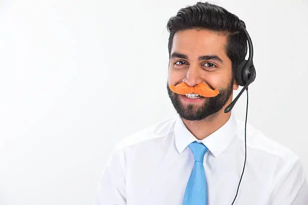 Photo of Indian Man Working in a Call Centre Messing About