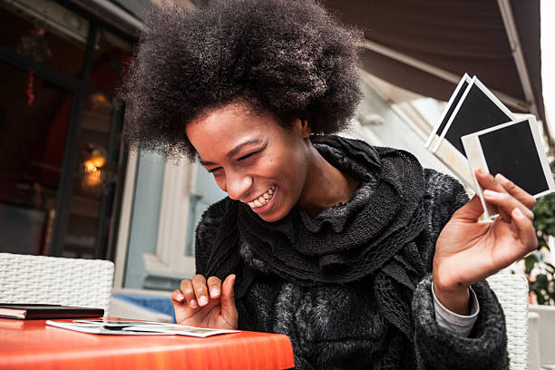 istock Young woman browses instant camera photo frames 488785644