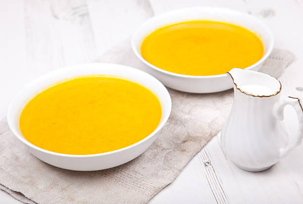 istock Two bowls of carrot soup on the white table 488786059