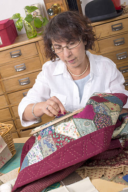 istock Mature woman by sewing and quilting 488786469