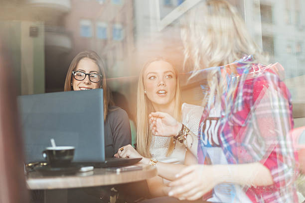 istock Three girls enjoying in a cafe 488786623