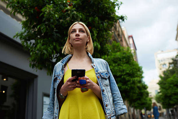 istock Charming woman chatting on her mobile phone during walking 488786726