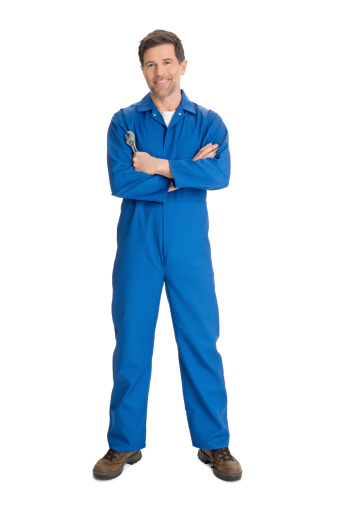 Full length portrait of confident repairman holding wrench while standing against white background