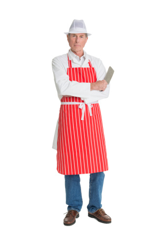 Full length portrait of confident butcher with meat cleaver standing against white background