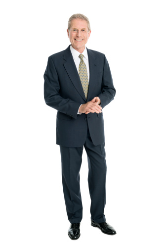 Full length portrait of smiling senior businessman standing against white background