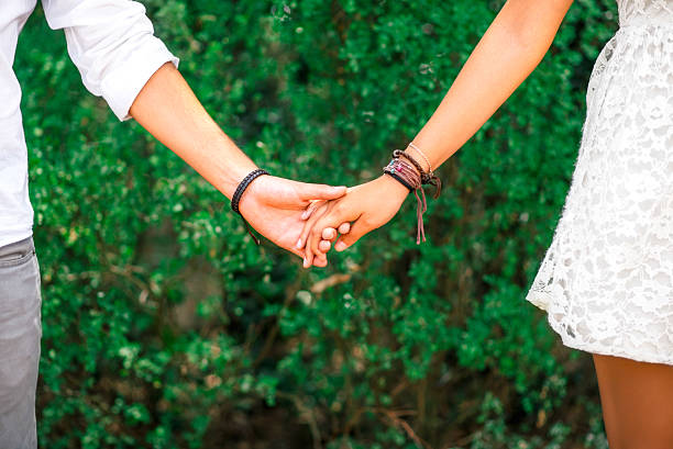 istock Close up of couple holding hands 488787040
