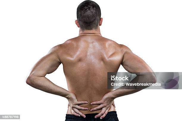 Rear View Of Shirtless Athlete With Back Pain Stock Photo - Download Image Now - 20-29 Years, 2015, 25-29 Years