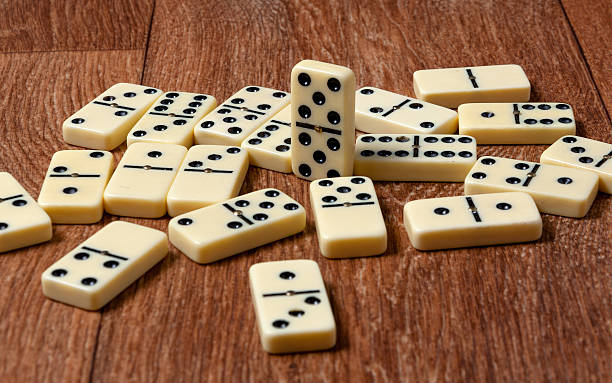 istock domino pieces on the brown wooden table background 488787490