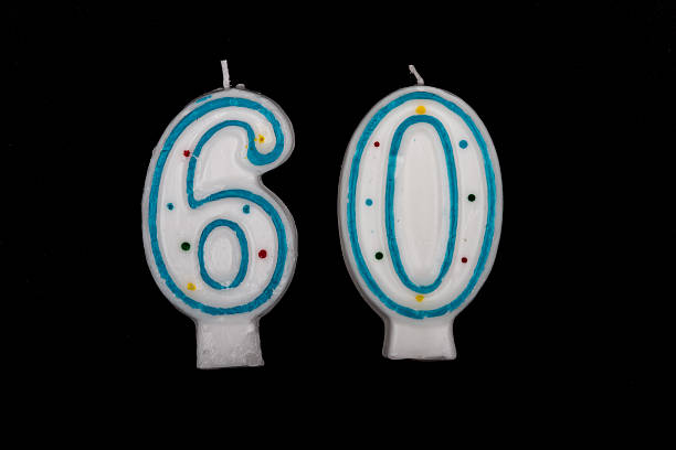 istock number 60 candle on black background 488787851