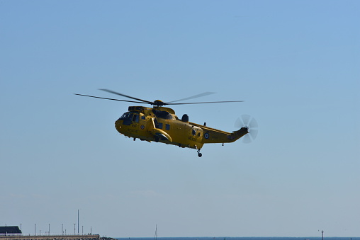 Jersey, U.K. - September 10, 2015:The RAF Sea King helicopter demonstrating a rescue at St Aubin Bay for the annual Airshow. The RAF assist the coastguard and RNLI in coastal rescues when required on British coastlines.