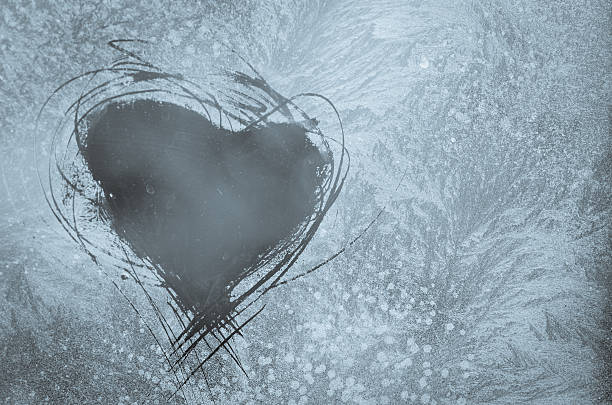 scratched heart on frosty window stock photo