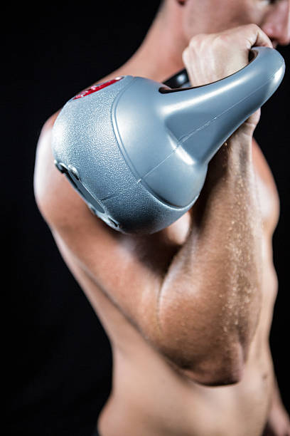 istock Midsection of shirtless athlete working out with kettlebell 488789508