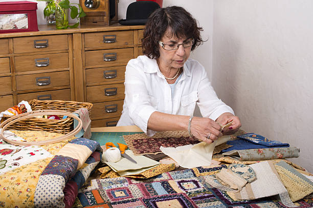 istock Mature woman by sewing and quilting 488789871