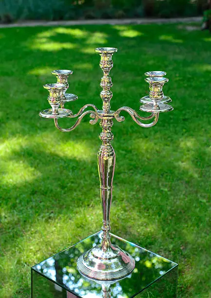 Luxury silver-plated candlestick like decoration for wedding on the green grass