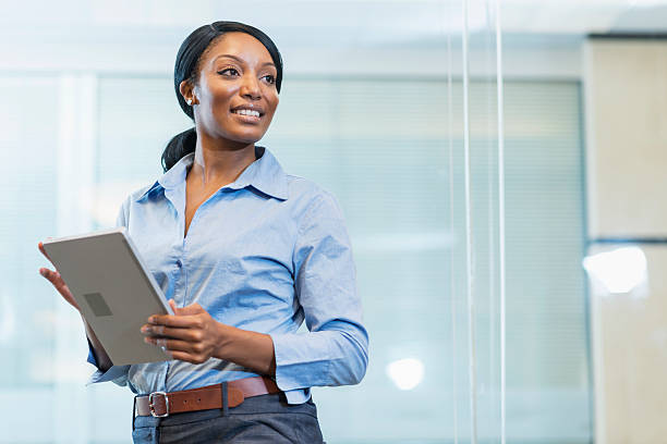 istock African American woman in office holding digital tablet 488793382