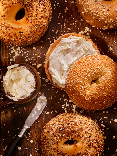 Bagels and Cream Cheese Toasted Bagels with Cream Cheese - Photographed on a Hasselblad H3D11-39 megapixel Camera System cream cheese photos stock pictures, royalty-free photos & images