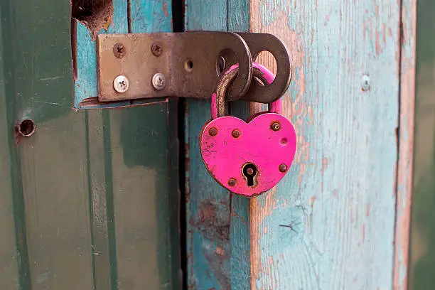 Pink door lock in the form of heart, close-up