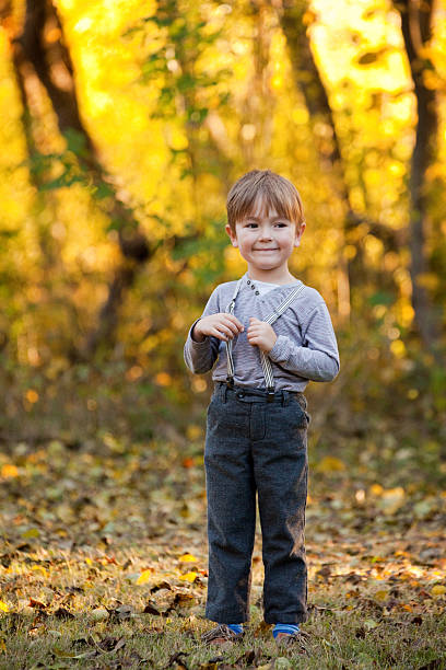istock Little Boy Smiling Outdoors with Autumn Colors 488797406