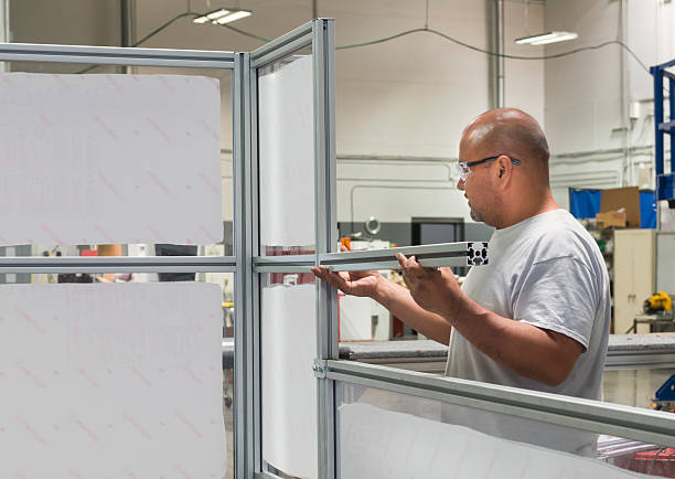 istock Mechanic Fitting Aluminum Framing Assembly at Manufacturing Plant 488799158