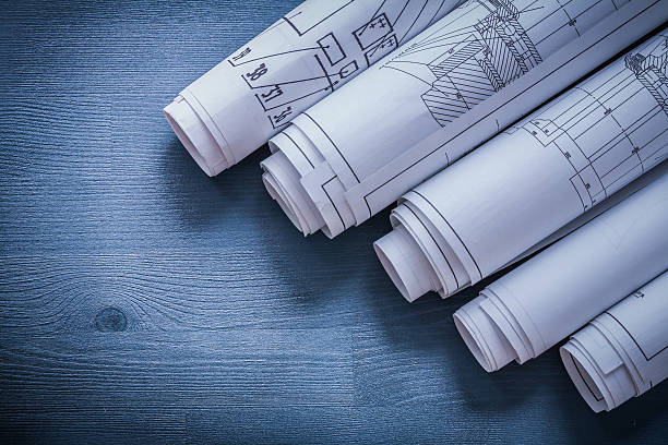 istock vertical view five rolls of blueprints very close up 488799160