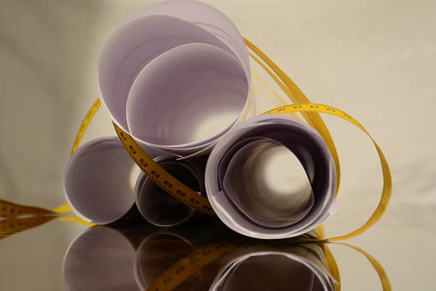 rolls of printed project wrapped with a measure tape