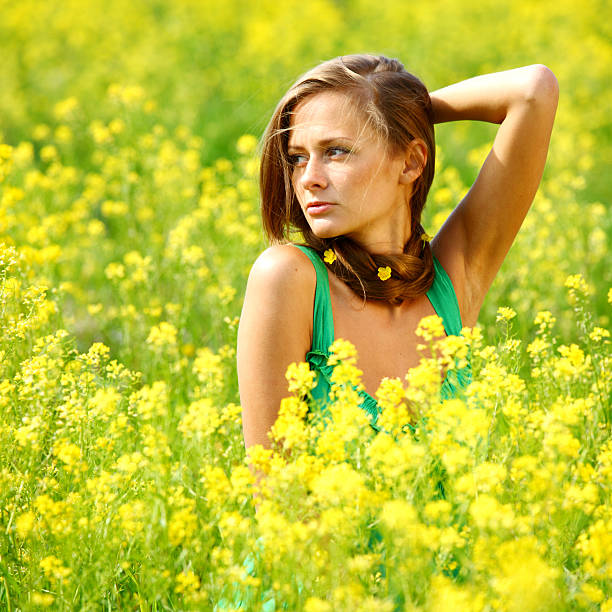 istock woman on oilseed field 488801235
