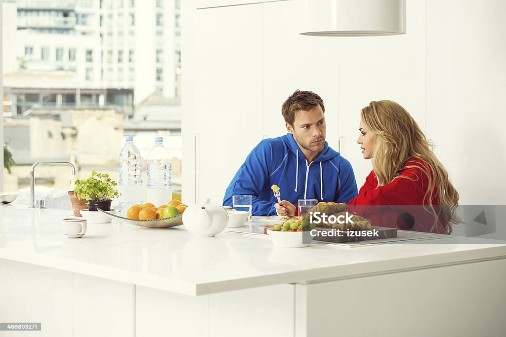Morning Young couple sitting in the modern kitchen in the morning and having breakfast.  Breakfast Stock Photo