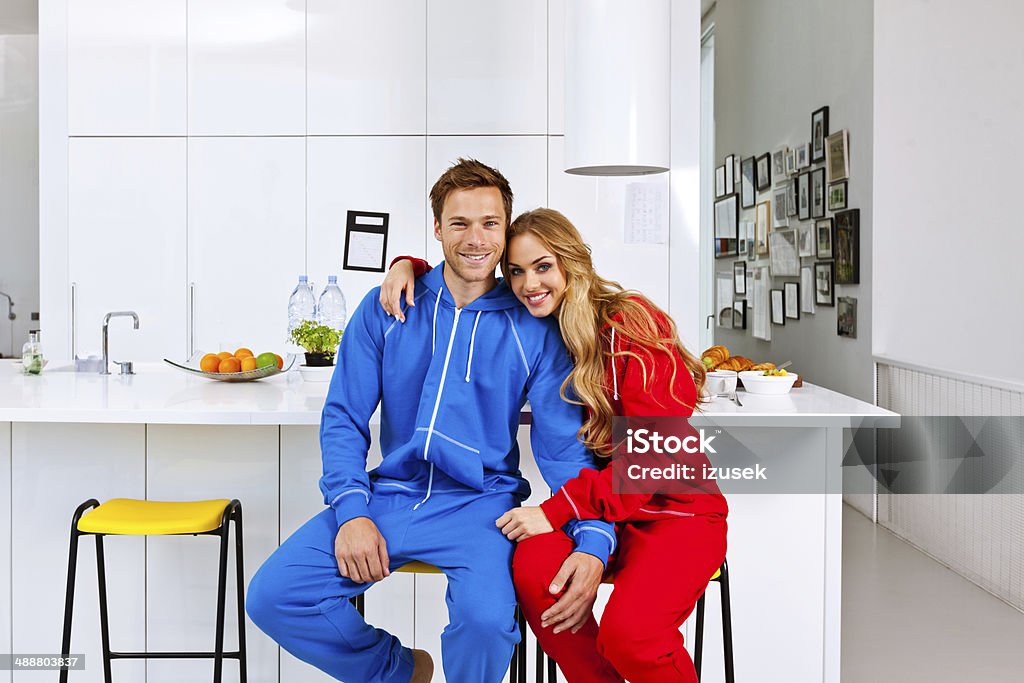 Happy morning Portrait of happy young couple sitting on chairs in the modern kitchen in the morning.  20-24 Years Stock Photo