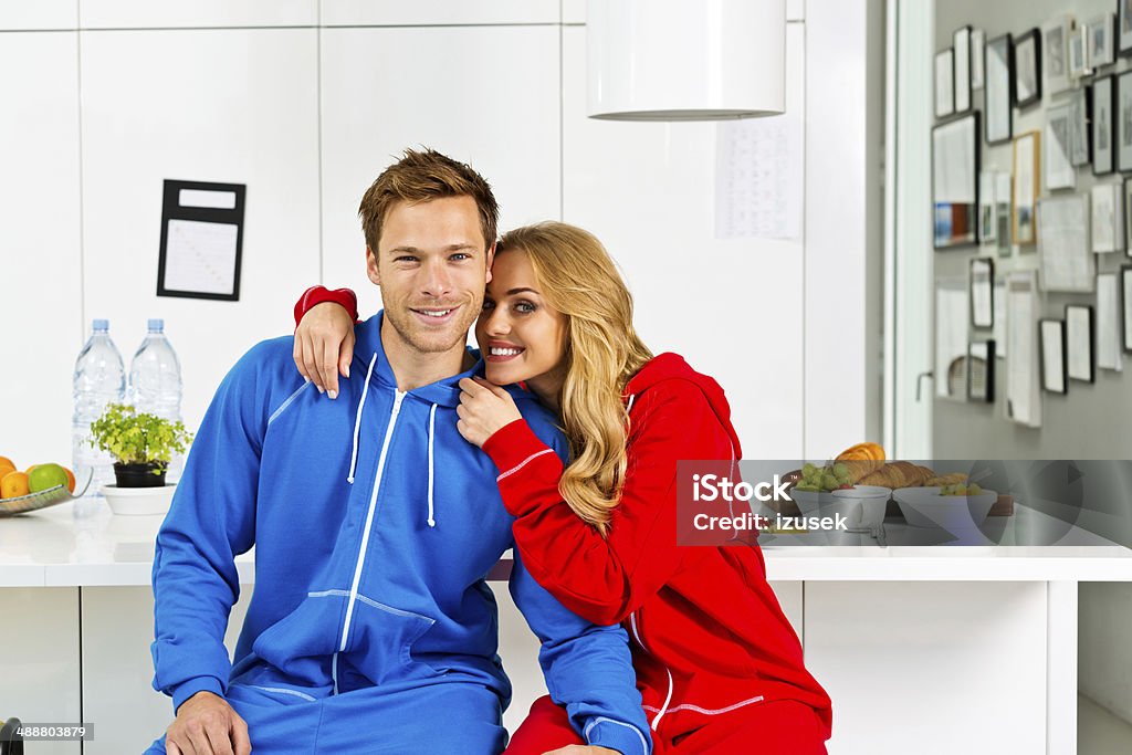 Happy morning Portrait of happy young couple sitting on chairs in the modern kitchen in the morning.  20-24 Years Stock Photo