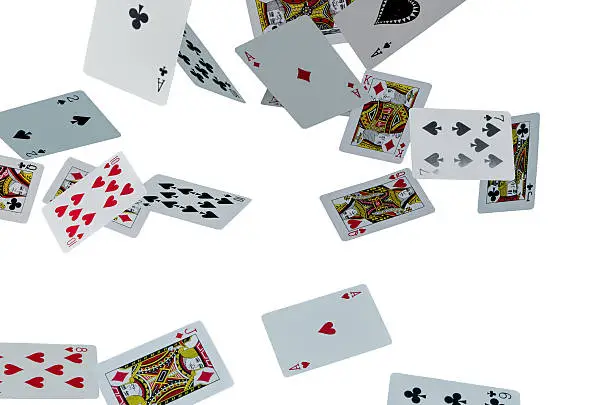 Playing cards flying in the air on white background