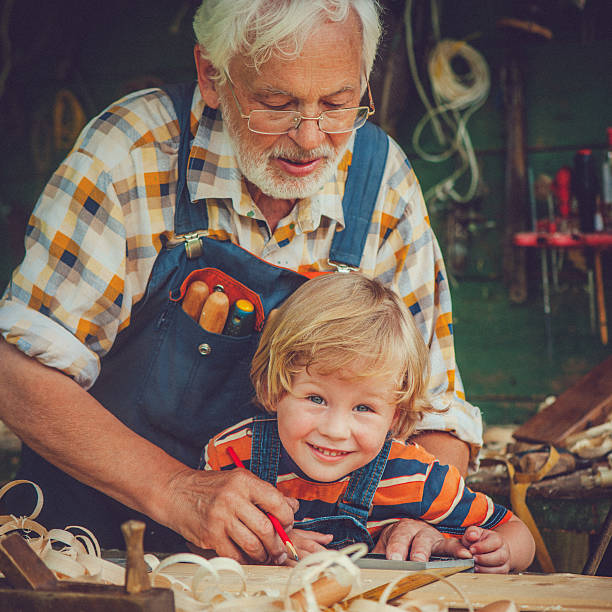 istock Grandfather and grandson in workshop 488806307