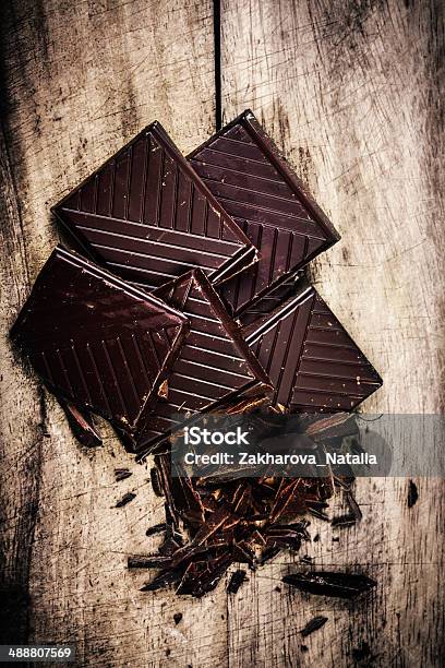 Chopped Chocolate Bar On Wooden Background Closeup Broken Stock Photo - Download Image Now