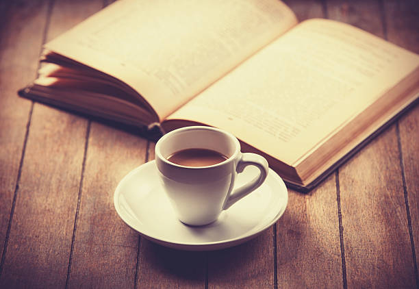 istock white cup of the coffee and vintage book. 488807655