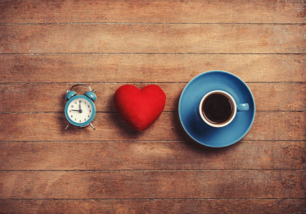 istock Clock, shape heart and cup of a coffee. 488808001