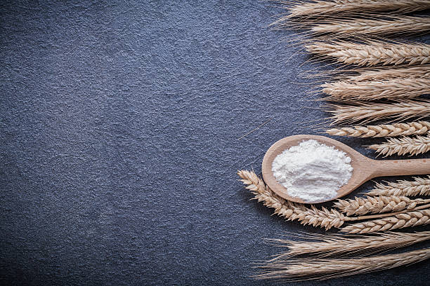 istock Wooden spoon flour wheat rye ears horizontal version 488811926