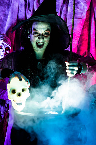 istock Halloween:  Witch cooking her brew for special guests. Zombie. Skull. 488814310
