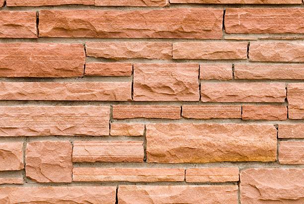 Sandstone Brickwork Close Up Close Up of a Wall Made of Various Dimensions of Sandstone Bricks roughhewn stock pictures, royalty-free photos & images
