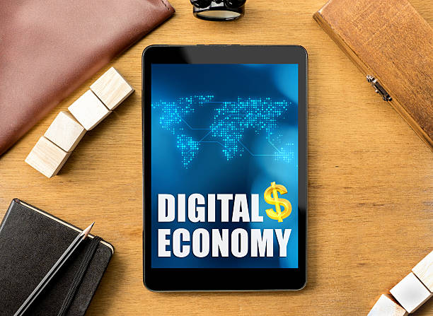 istock Digital Economy word on tablet with clock ,box,notebook,leather 488815836